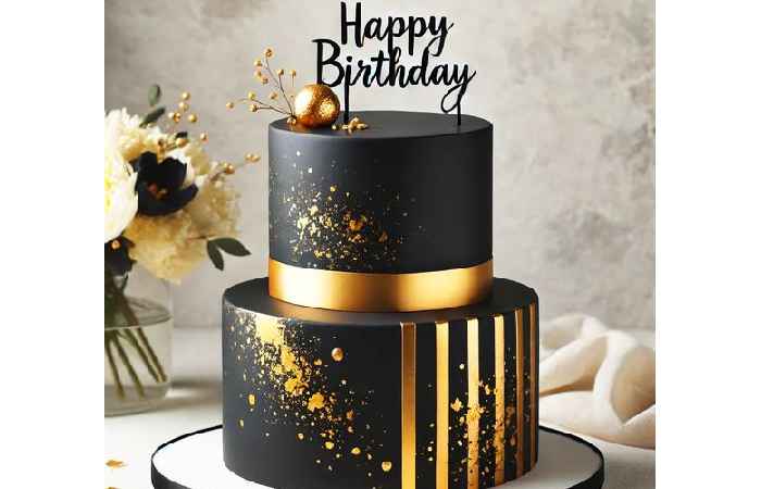 Modern two-tier black and gold cake with gold stripes and splatter